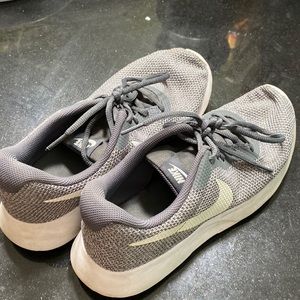 Gray Nike lace up sneakers with a white swoosh in great shape size 9
